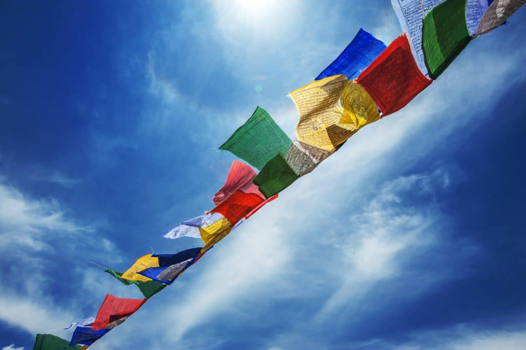 tibetan flags with mantra on sky background